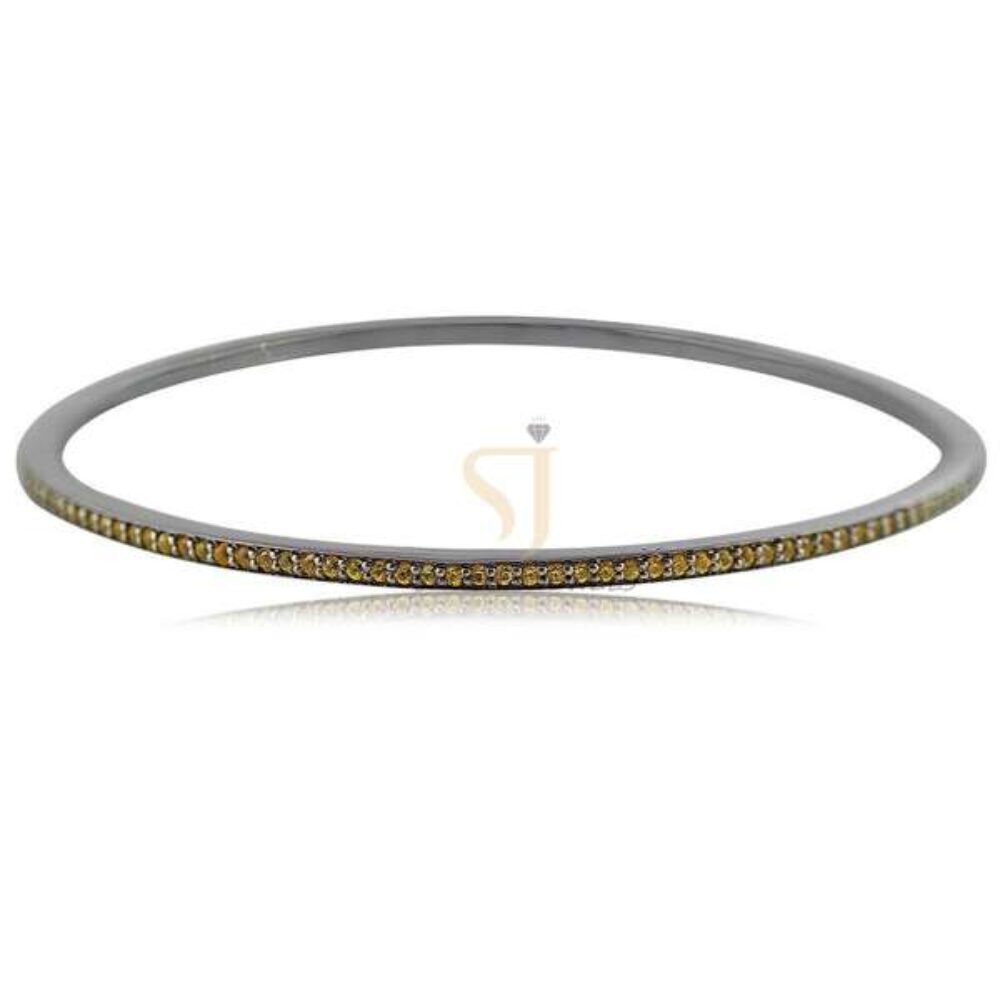 📝 Product Description Elevate your jewelry collection with this 925 sterling silver two-tone tennis bangle, designed for a modern yet timeless appeal. Featuring a sleek silver-tone body accented with a row of warm gold-tone cubic zirconia stones, this bracelet delivers a unique dual-color elegance that stands out effortlessly. The slim and lightweight structure makes it perfect for stacking or wearing solo for a refined, minimal look. Ideal for both everyday wear and special occasions, this bangle blends sophistication with versatility. ✨ Key Features Crafted from 925 Sterling Silver Elegant two-tone finish (Silver + Gold accents) High-quality Cubic Zirconia stones for diamond-like sparkle Slim, minimal & stackable design Lightweight and comfortable for daily wear Secure lock mechanism Tarnish-resistant with premium polish 📏 Product Specifications Material: 925 Sterling Silver Stone Type: Cubic Zirconia Finish: High Polish / Two-Tone Plating Colors: Silver with Gold Accent Style: Tennis Bangle / Minimal Bracelet Gender: Women Occasion: Daily Wear, Party, Wedding, Office Wear Closure Type: Lock / Push Clasp Diameter: (Add your actual size e.g., 2.2”, 2.4”) Weight: (Add if available) 🎁 Perfect For Birthday Gift for Her Anniversary Gift Wedding Jewelry Bridesmaid Gift Minimal Everyday Jewelry Lovers 💎 Care Instructions Keep away from water, perfumes, and harsh chemicals Store in a dry, soft-lined jewelry box Clean gently with a soft cloth